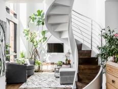 White and Gray Living Room With Plants and Spiral Staircase