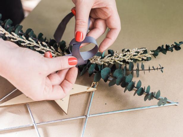 Step 3- Add RibbonTie a ribbon or two onto the floral bunch to give it a finished look (this hides the floral tape!) Use coordinating ribbons to give it more depth. Next, cut off a small section of ribbon and loop it through the wreath to create a hanger.