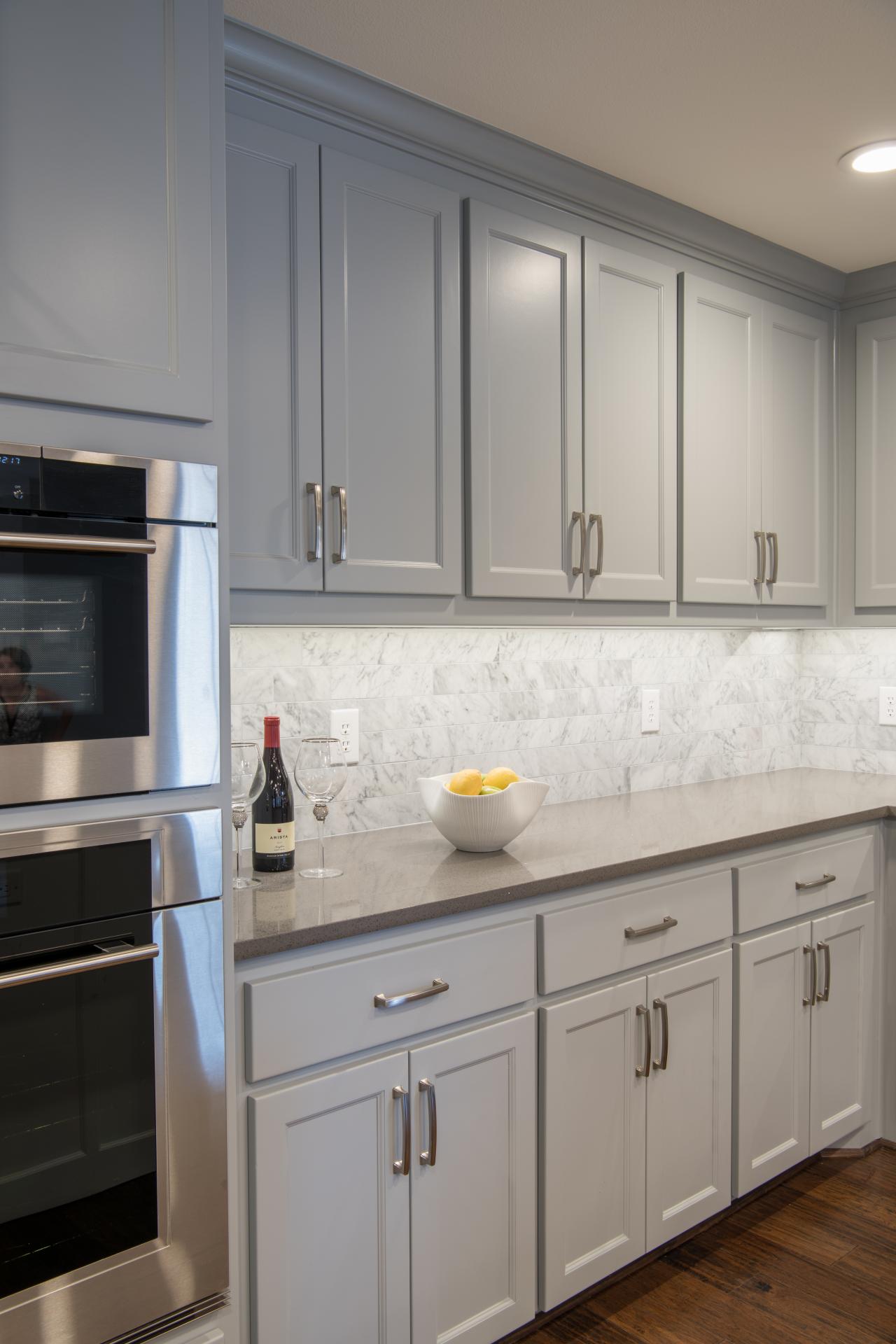 Modern White Kitchen Cabinets And Grey Backsplash with Simple Decor