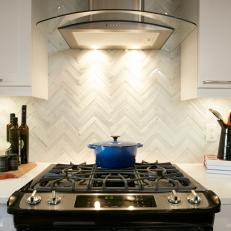 Chevron Tile Kitchen Backsplash Under Glass and Stainless Steel Range Hood 