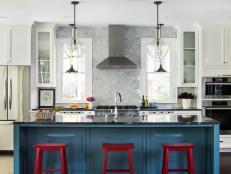 Modern Luxury Kitchen with Blue Island and Red Stools