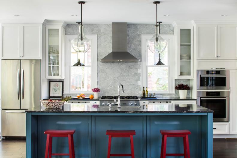 Modern Luxury Kitchen with Blue Island and Red Stools