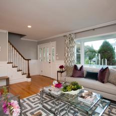 Two-Tone Living Room Walls Around Neutral Sofa, Layered Glass Coffee Table and Patterned Curtains 