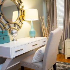 White Desk Workspace With Upholstered Chair, Turquoise Accents and Decorative Gold Wall Mirror 