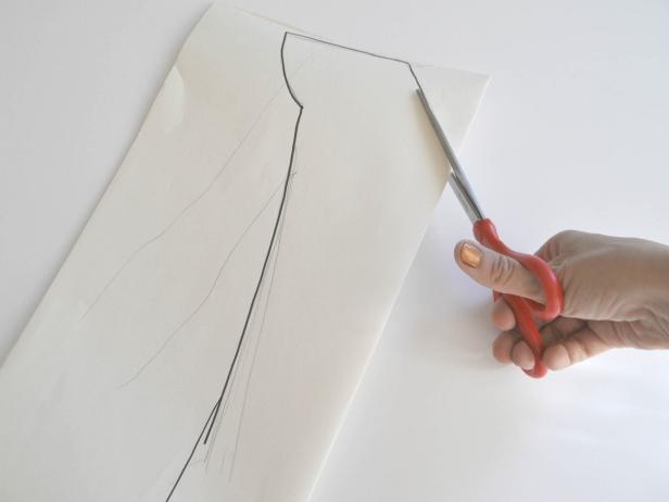 Lay the costume wearer on top of large sheet of paper and trace outline of upper body with pencil. Use outline to sketch armor. Shoulders should extend just beyond normal shoulder size and round down. Continue outline down just inside the width of the body. Extend lines 3 inches below waist. Outline pattern with marker for clarity. Cut out pattern. Tip: Fold paper in half lengthwise to ensure that the pattern created is symmetrical.