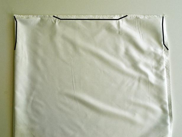 Invert pillowcase. Cut lines where shown. Seal cut edges of fabric to avoid fraying. To do so, melt edges over a flame. Do not put fabric in flame. Simply bring it close and watch it melt the edge. Edge will become slightly hardened and will not fray. Do not involve children in this process. Tip: If purchased pillowcase is not made of polyester or microfiber use Fray Check to prevent fraying instead. Squirt gently onto edges of fabric. Invert pillowcase and iron.