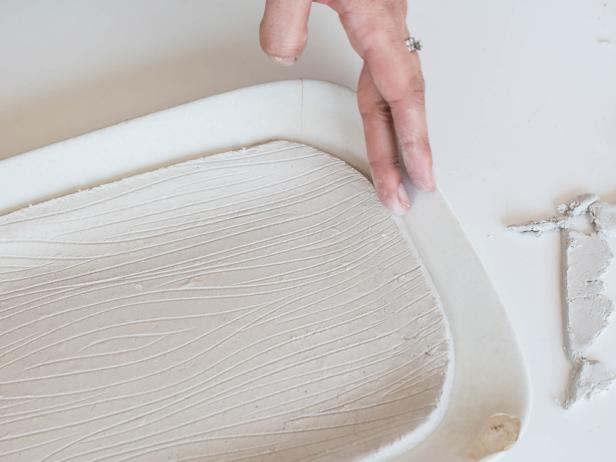 Carefully place clay inside a platter, bowl, or plate in desired shape. Gently press clay into the form of platter. Don't press too hard or the design will be damaged. Cut rough edges with plastic knife and smooth out with a finger. The edges will be sanded once clay is dry, so it doesn't have to be perfect at this stage. Allow clay to dry until hardened per instructions (usually about 24-72 hours).