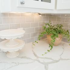 Contemporary White Kitchen with Gray Tile Backsplash 