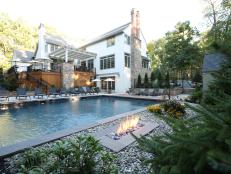 two story home with pool, fire pit, deck and exposed stone