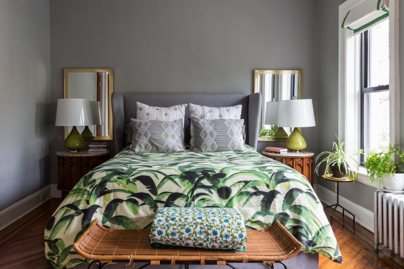 The master bedroom is a serene affair. The perfect place to rest and relax after a long day. It combines the couple’s love of banana-leaf prints with soft grays and warm wood tones. In this restful retreat, a few plants become the perfect accessories. 
