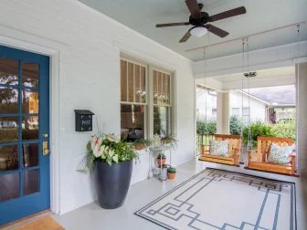 Neutral Porch with Two Brown Wooden Swings 
