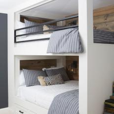 Built-in Bunk Beds With Shiplap Paneling and Iron Railings