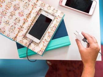 Transform an old book into this chic DIY phone charging station with loads of charm.
