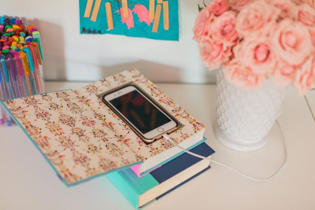 Transform an old book into this chic DIY phone charging station with loads of charm.