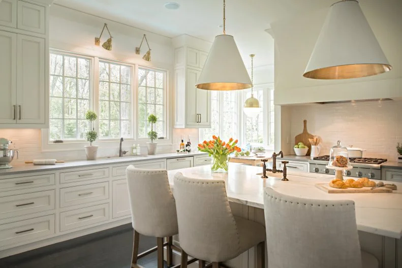 White Eat-In Kitchen With Large Island and Pendant Lights