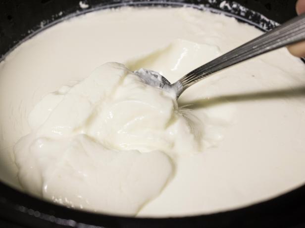 Making DIY yogurt with the help of a slow cooker.