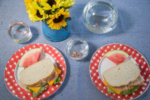 table with plates of sandwhiches