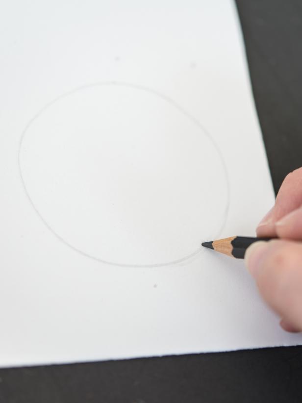 On white craft foam, use pencil to draw out a circle, about 3â in diameter. Cut out with scissors. Use first circle as a template to trace second white circle. Cut out second circle. Repeat this process with black foam, making two circles about 1/2â in diameter. Tip: Trace a drinking glass to create two white circles.