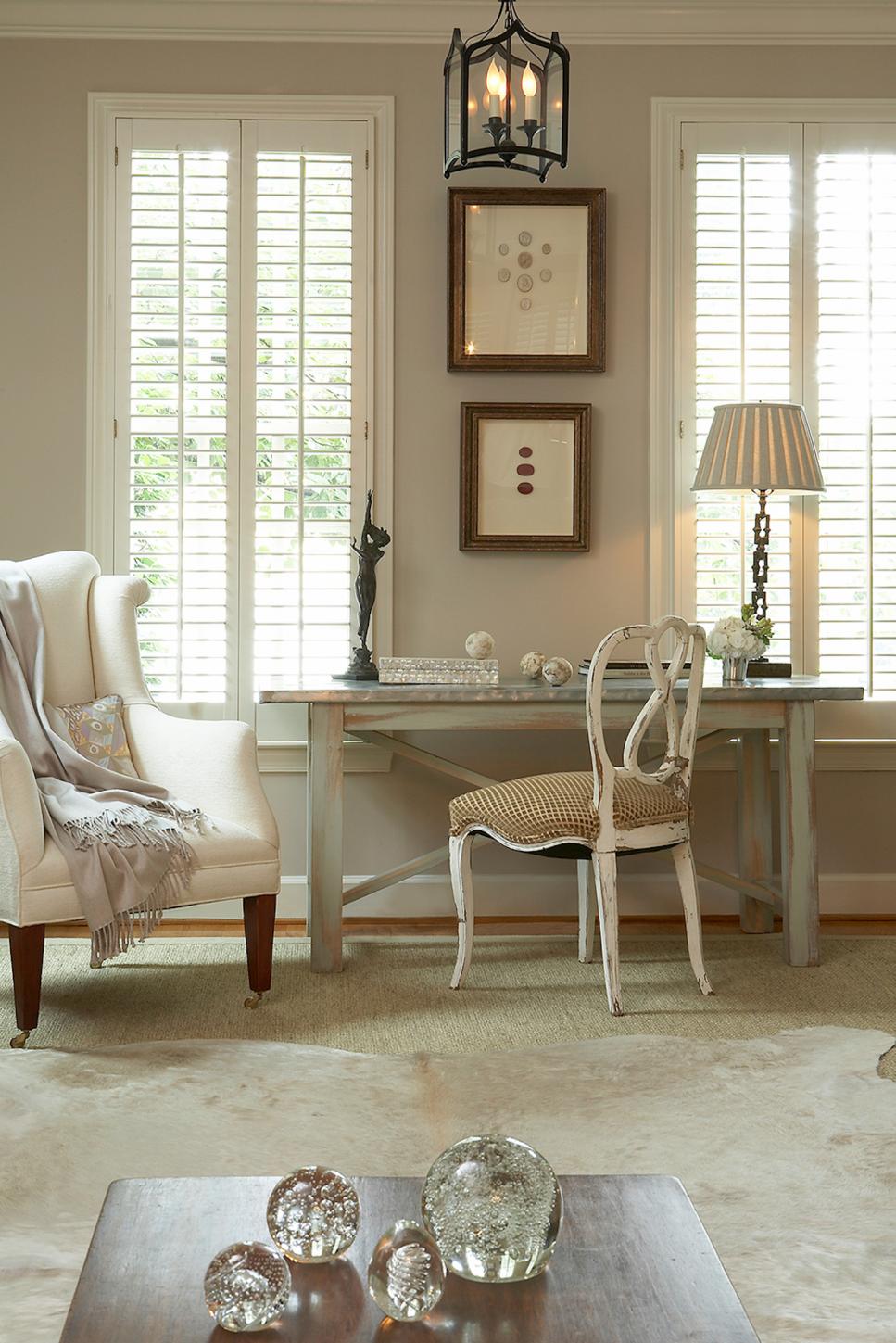 Chic Neutral Living Space with Desk and Glass Orbs on Coffee Table Chic Neutral Living Space with Desk and Glass Orbs on Coffee Table