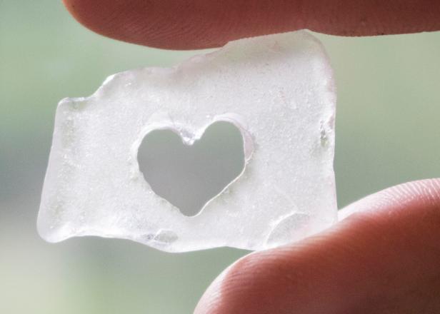 Use a rotary tool to cut hearts and designs into pieces of beach glass.