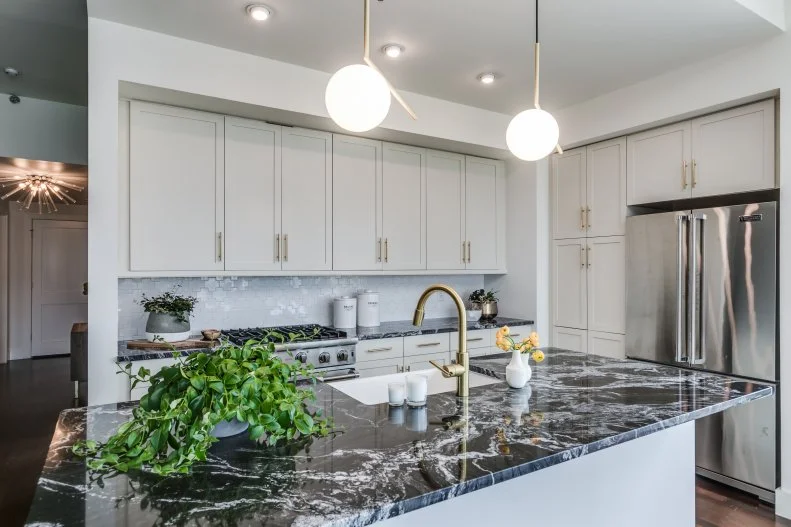 White Open Kitchen With Black Countertops