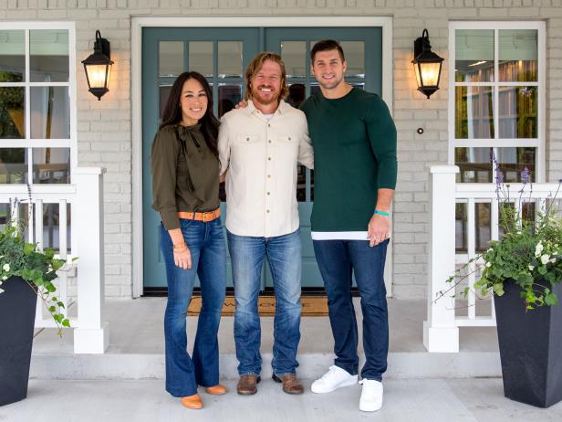 Chip and Joanna Gaines with Tim Tebow on the front porch of the Copp's newly renovated, as seen on Fixer Upper.