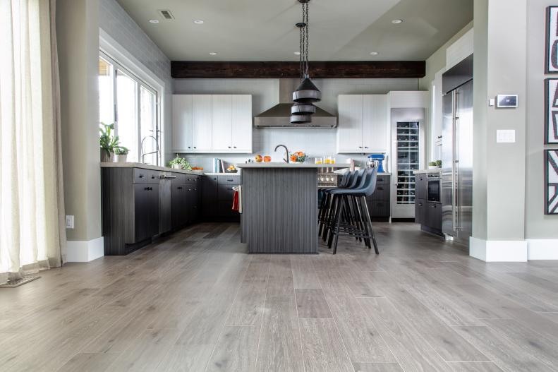 This wide view of the kitchen highlights the engineered flooring that helps create a connection and great flow between the kitchen and the main living areas of the home. 
