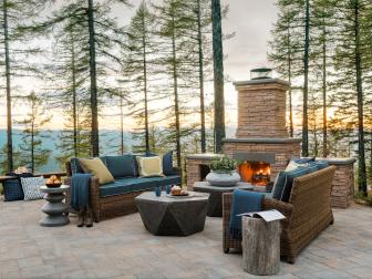 Outdoor Sitting Area Has Sofas, Coffee Tables and Stone Fireplace