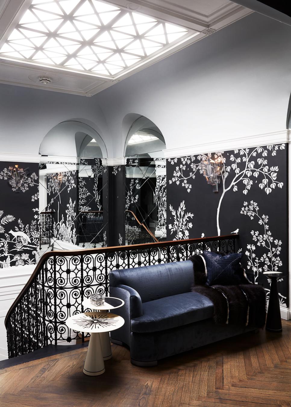 Grand Stairwell with Wrought-Iron Railing, Sunlight and Bontaical Wall Mural Luxury Mirrored Stairway with Wrought-Iron Railing, Sunlight and Wall Mural