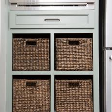 White Cottage Kitchen with Brown Wicker Baskets in Green Cabinet  