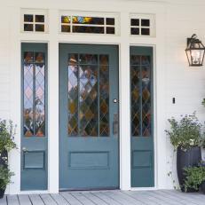 White Farmhouse Home Exterior with Blue Front Door 