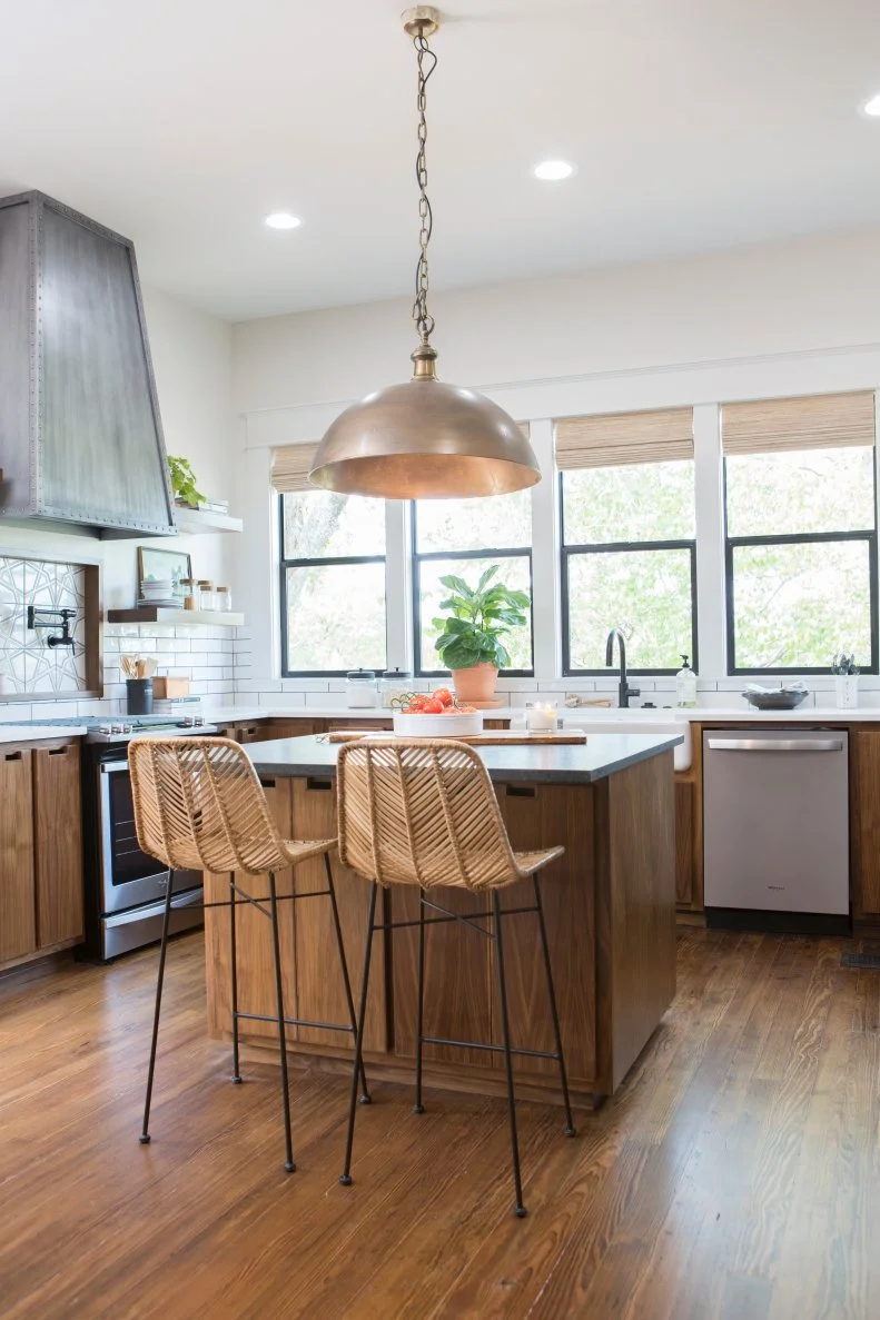 Neutral Kitchen with a Brown Kitchen Island and Chairs 
