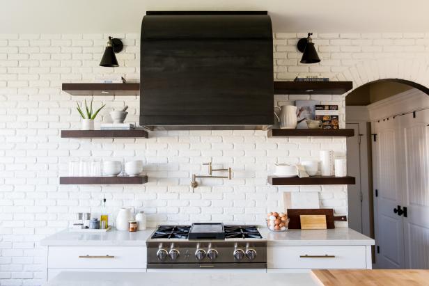 open-concept kitchen with black range hood