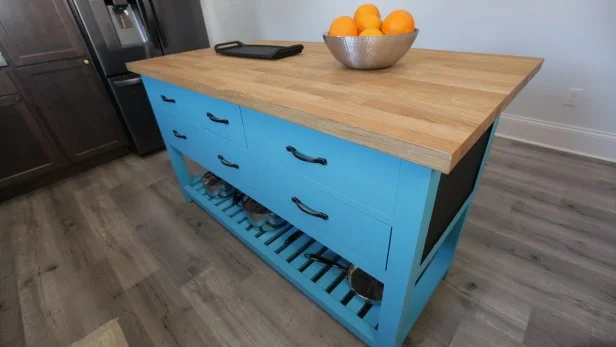 The new bright blue kitchen island in the Sanders townhome that Karen and Mina renovated together as seen on Good Bones 