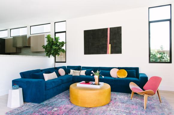 Modern Living Room With Blue Sectional Sofa And Pink Midcentury Modern Side Chair Living Room With Colorful Midcentury Modern Furnishings