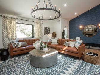 The living room of Drew Scott’s home has been completely transformed and features an open space concept leading to the dining room and kitchen, a new fireplace, and eco-skylights bringing in natural lighting, as seen on Brother vs Brother.  (Before 0024).