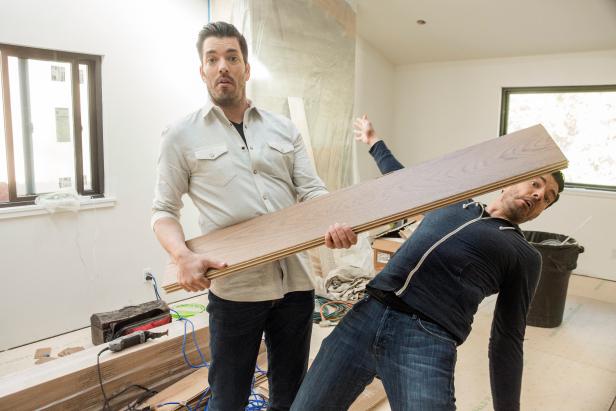 Hosts Jonathan Scott and Drew Scott have some fun in Drew's house living room, as seen on Brother vs. Brother.