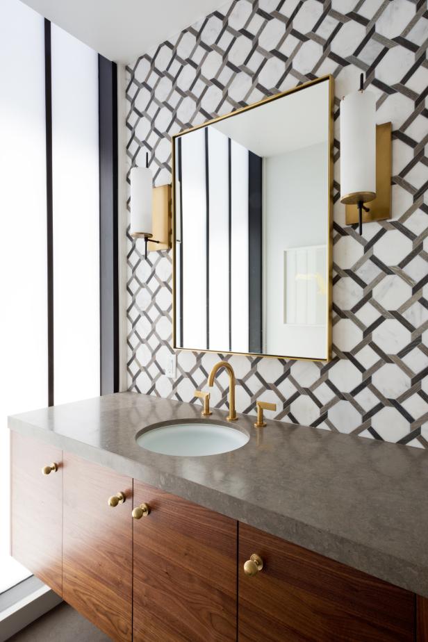 Modern Powder Room With Wallpaper Accent Wall And Gold Sconces