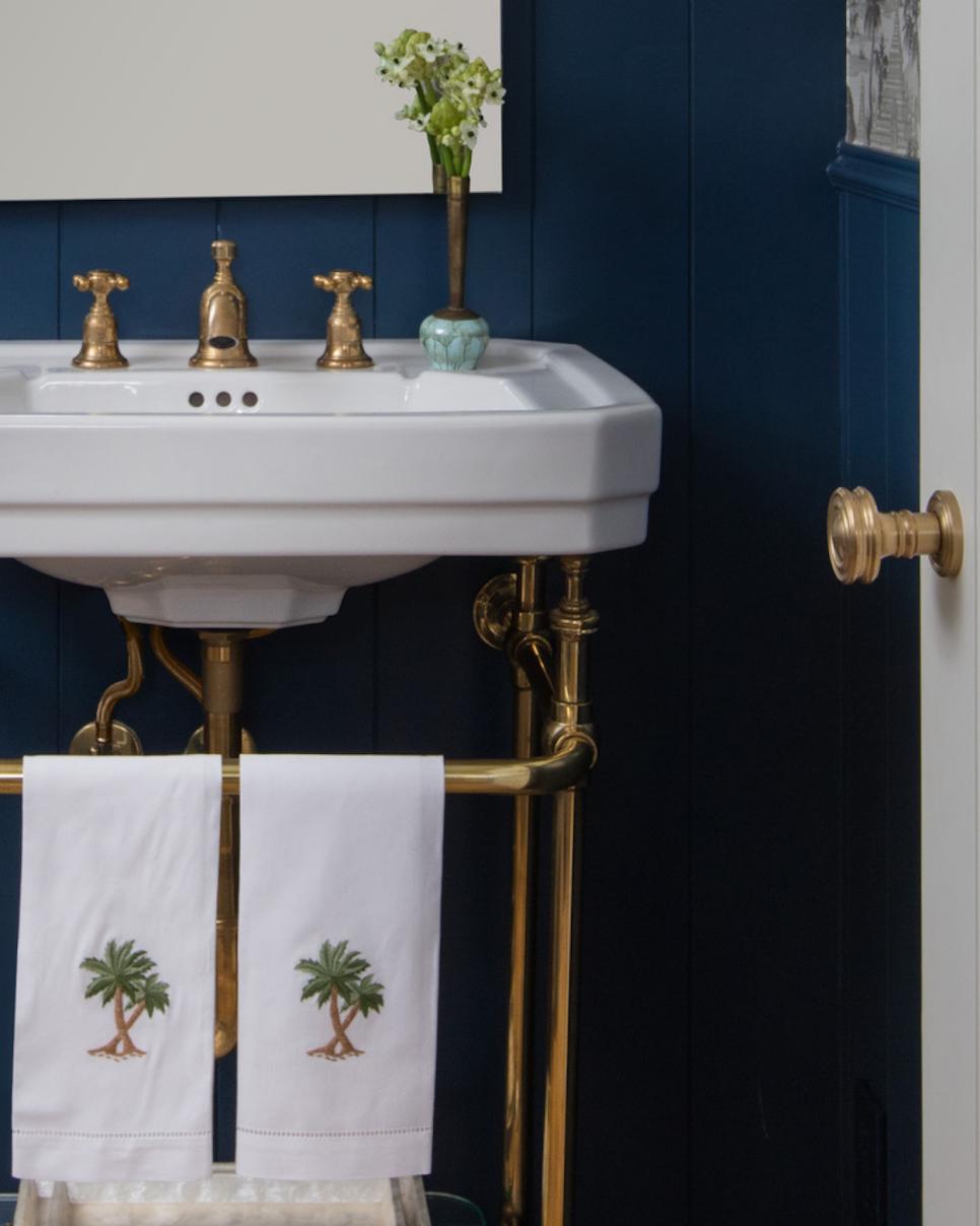 Brass Hardware Shines in Blue Powder Room transitional blue powder room