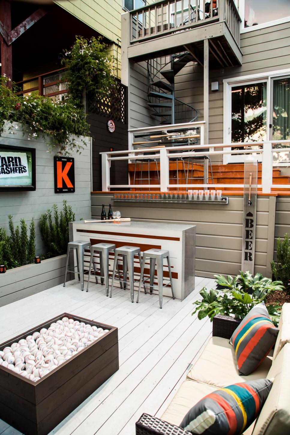 White Deck With Colorful Pillows and Green Potted Plants White Deck With Touches of Warm Color