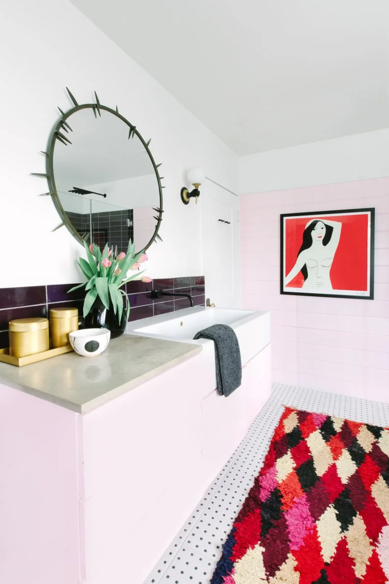 eclectic bathroom with pink accent wall