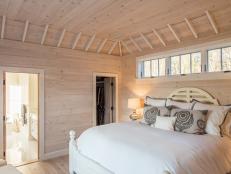 Modern Cottage Master Bedroom With Light Pine Paneled Walls And Ceiling