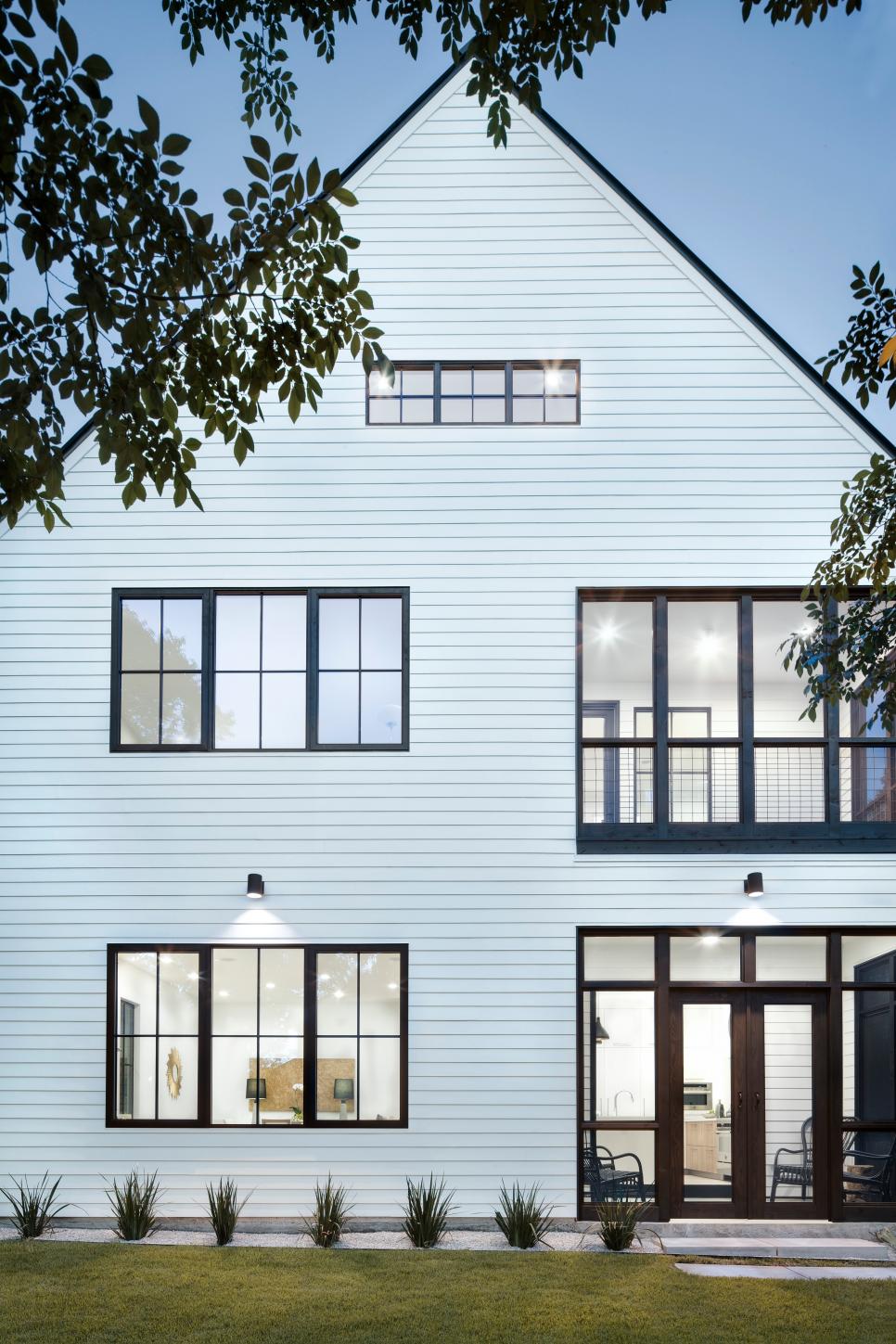 Modern White Farmhouse With Dormer Roof And Screened Porches Modern Farmhouse With Stacked Screened Porches