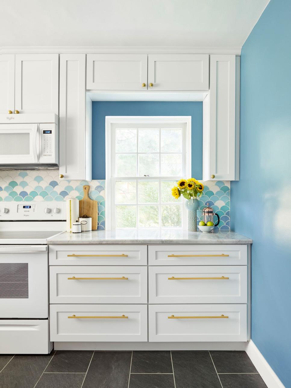 White Kitchen Cabinets With Golden Hardware contemporary white kitchen with blue backsplash