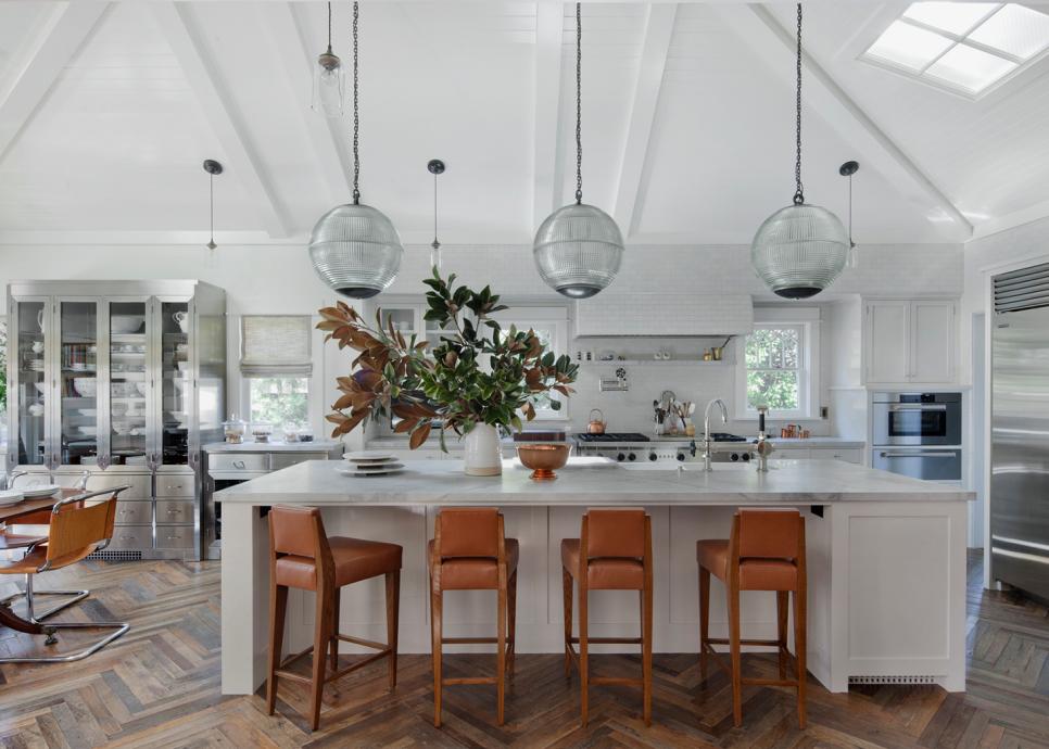 Open, Transitional Dine-In Kitchen With Leather Bar Chairs, Long Pendant Lights and Large Island White Transitional Kitchen
