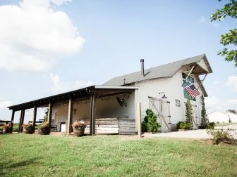 White Farmhouse Has Large Side Porch