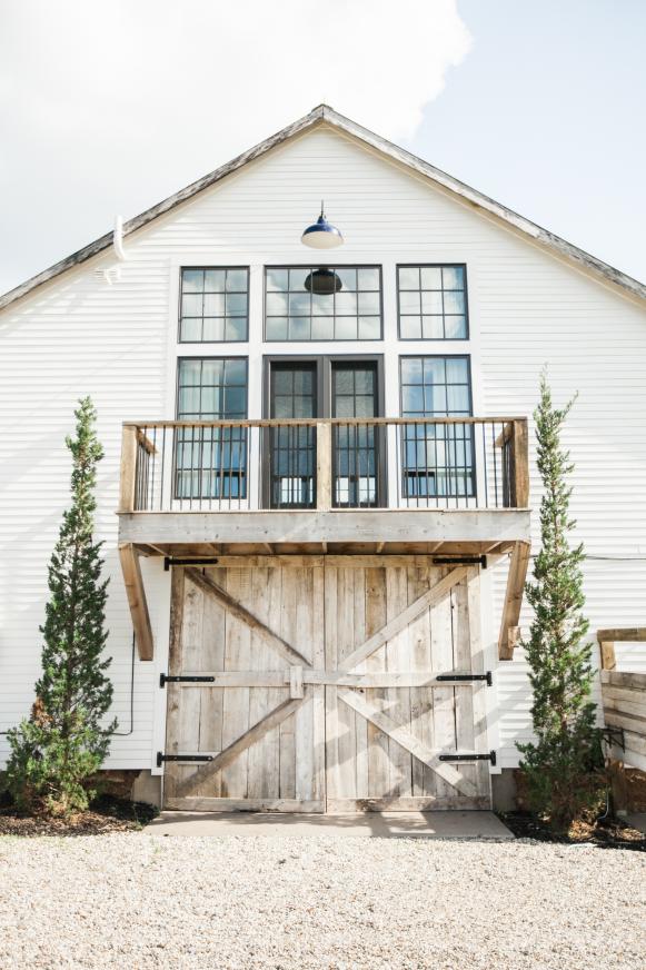 Farmhouse Features Barn Doors and Large Windows