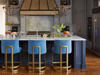 Classic Kitchen With Modern Upholstered Bar Stools And Pendants