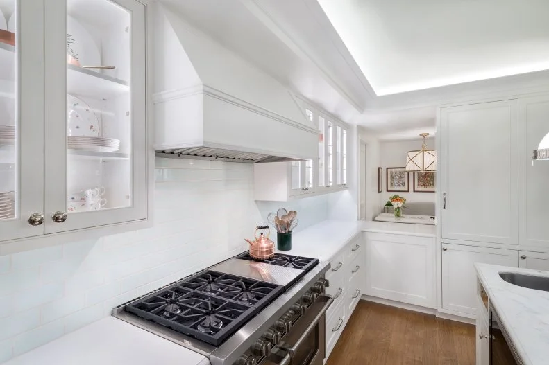 Traditional Kitchen With White Cabinets And Recessed Lighting