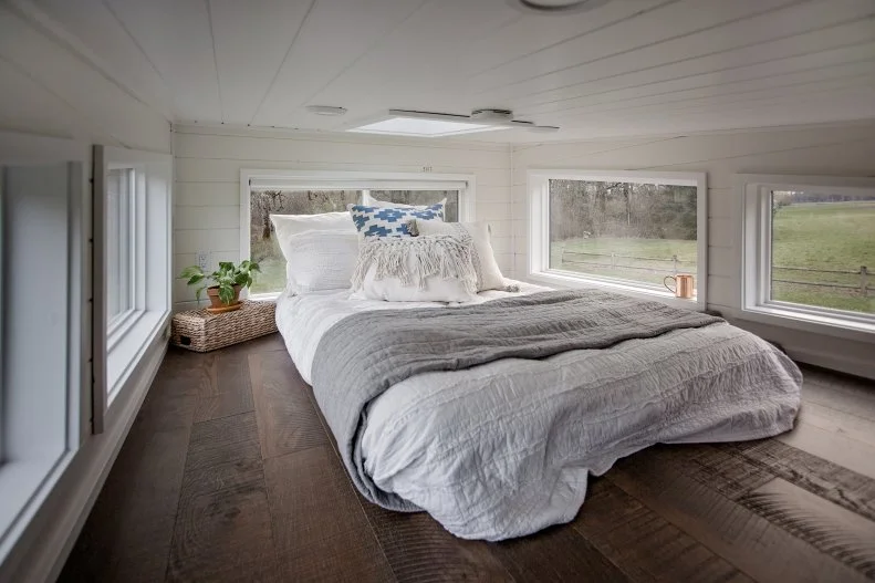 Tiny House Loft Bedroom With White Walls And Stained Wood Floor